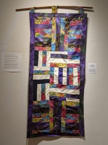 Leanora E. Mims • <em>Say Her name: Sunrise, Sandra Bland</em> • Cross square quilting pattern • 23“×48“ • $950.00<a class="purchase" href="https://state-of-the-art-gallery.square.site/product/leanora-e-mims-sunrise-quilted-wall-hanging/385" target="_blank">Buy</a>